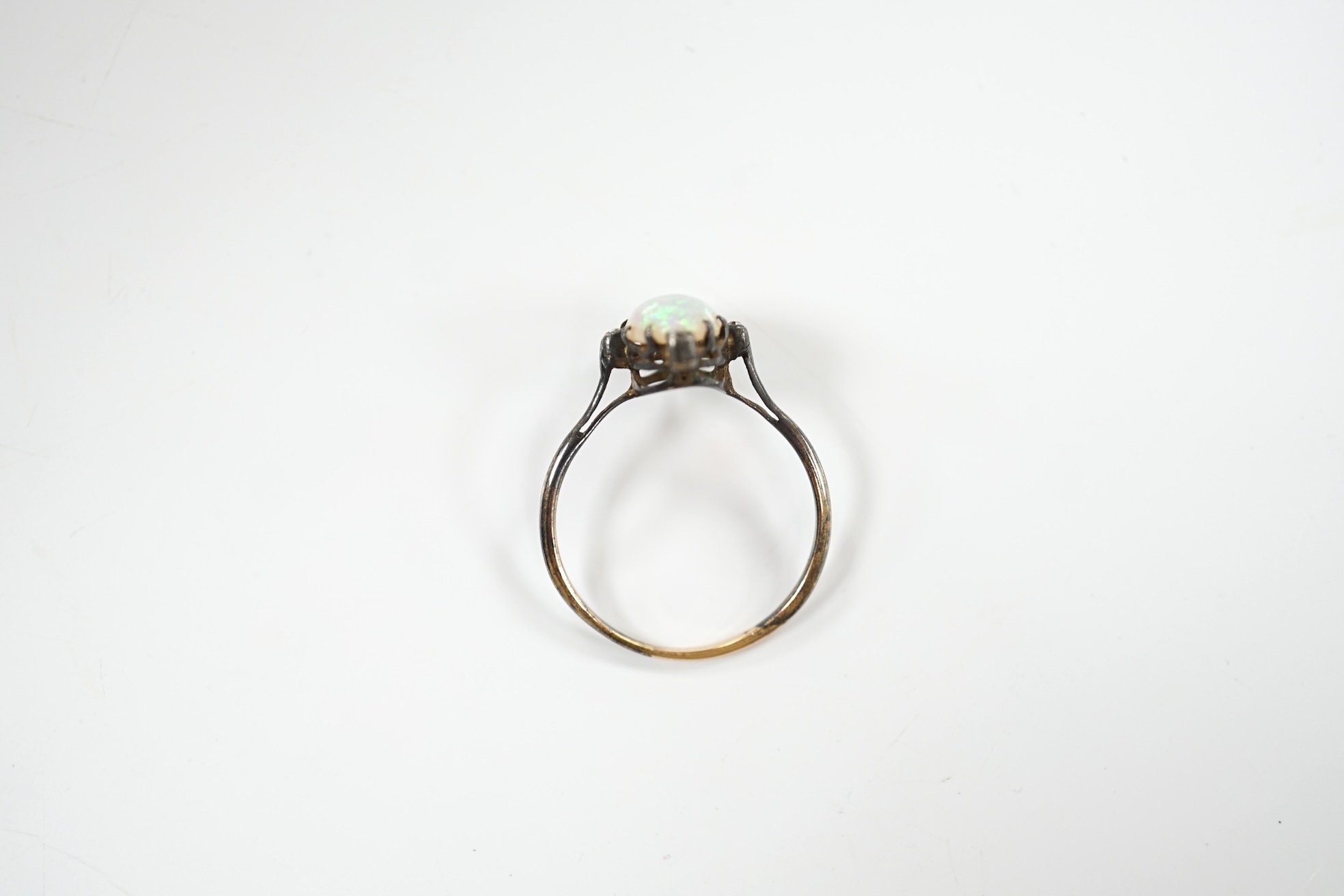 An antique, yellow and white metal, white opal and diamond set ring, size T, gross weight 2.1 grams. Condition - poor to fair